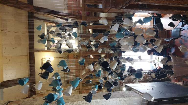 Cup sculpture hanging from the ceiling