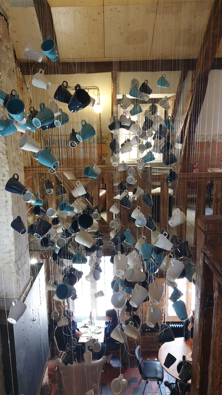 Cup sculpture hanging from the ceiling